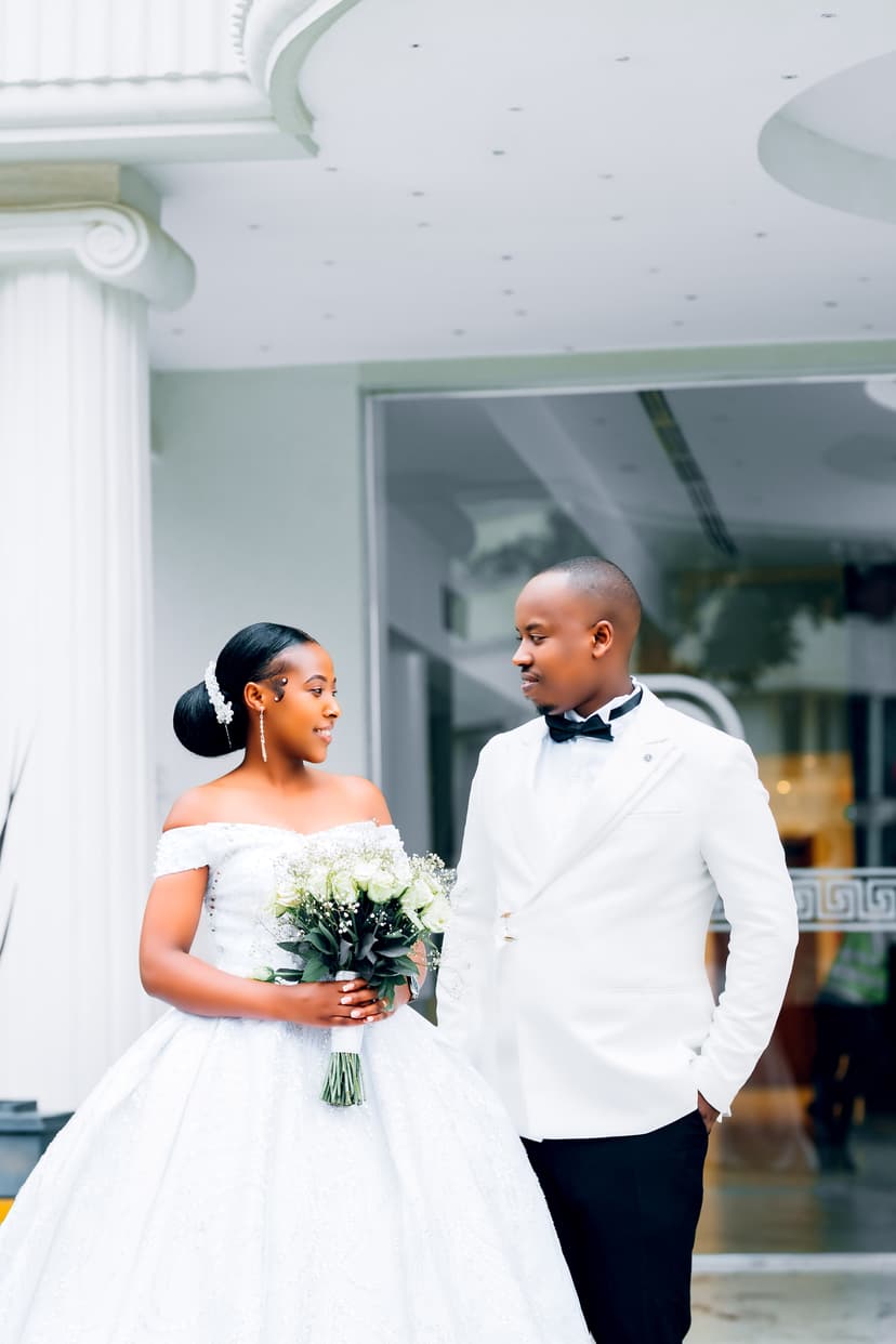 Bride with flowers and groom walking outside venue