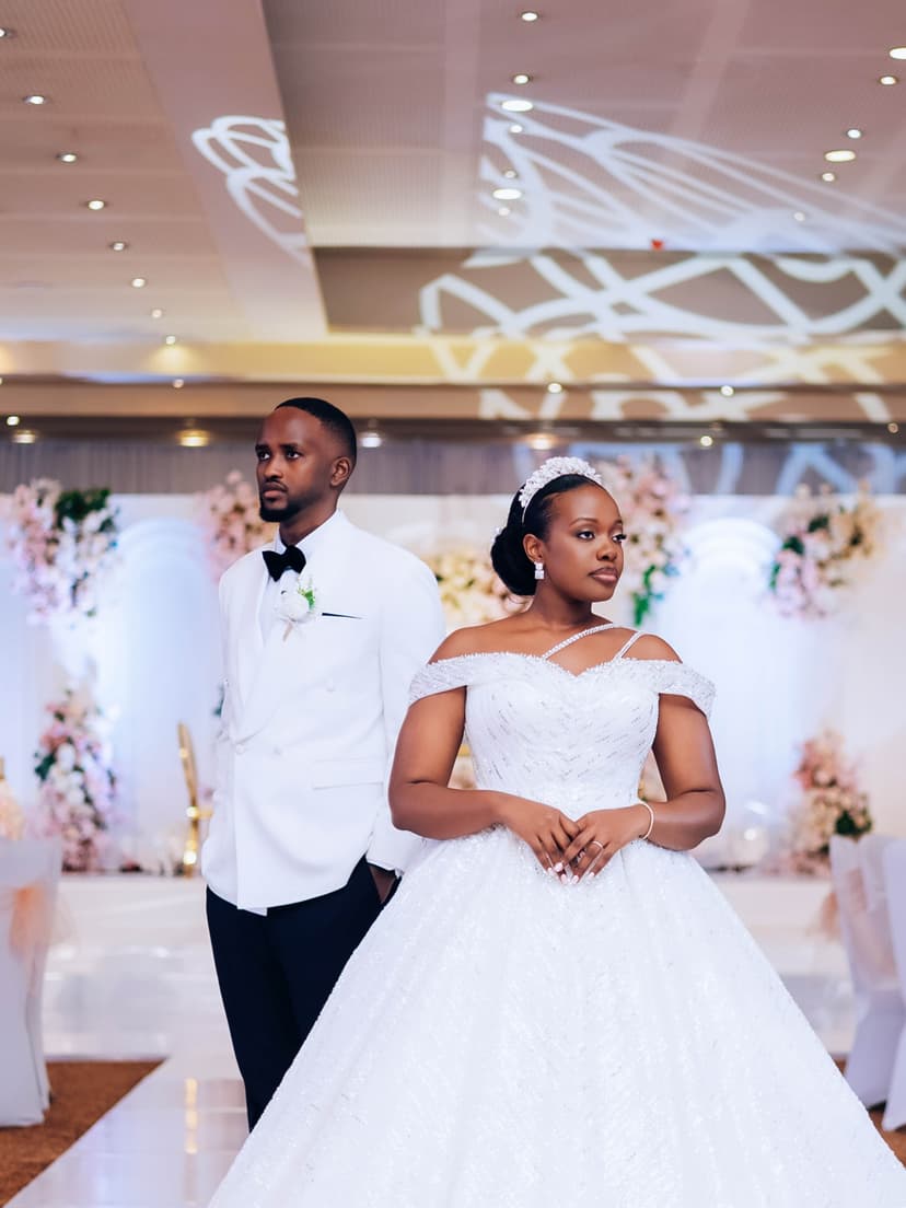 Couple at ceremony with floral backdrop
