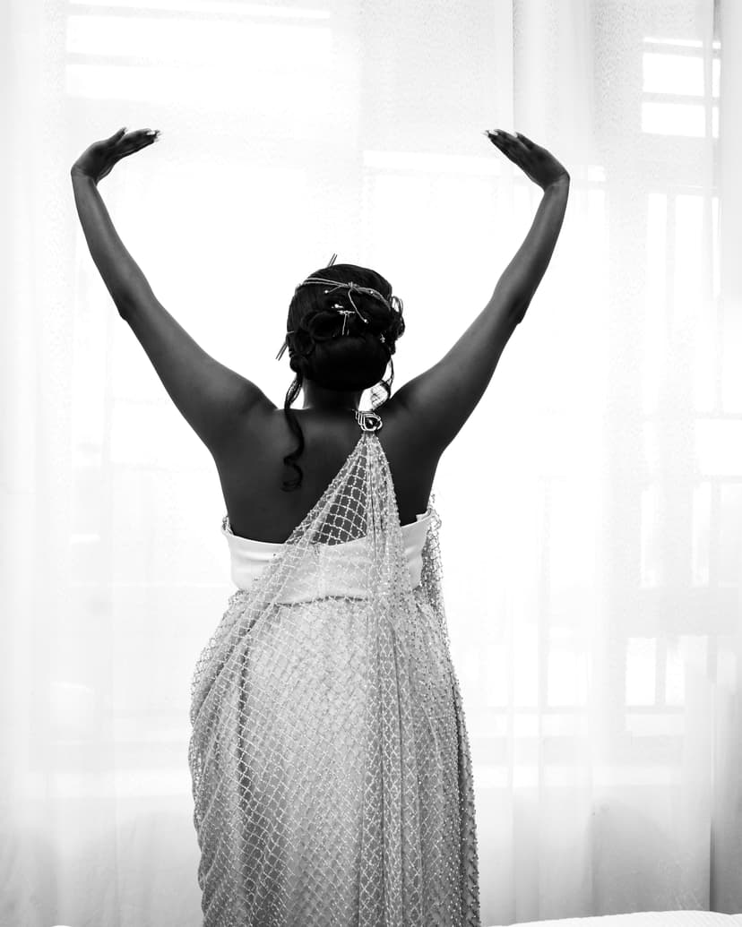 Black and white bride from behind with arms raised