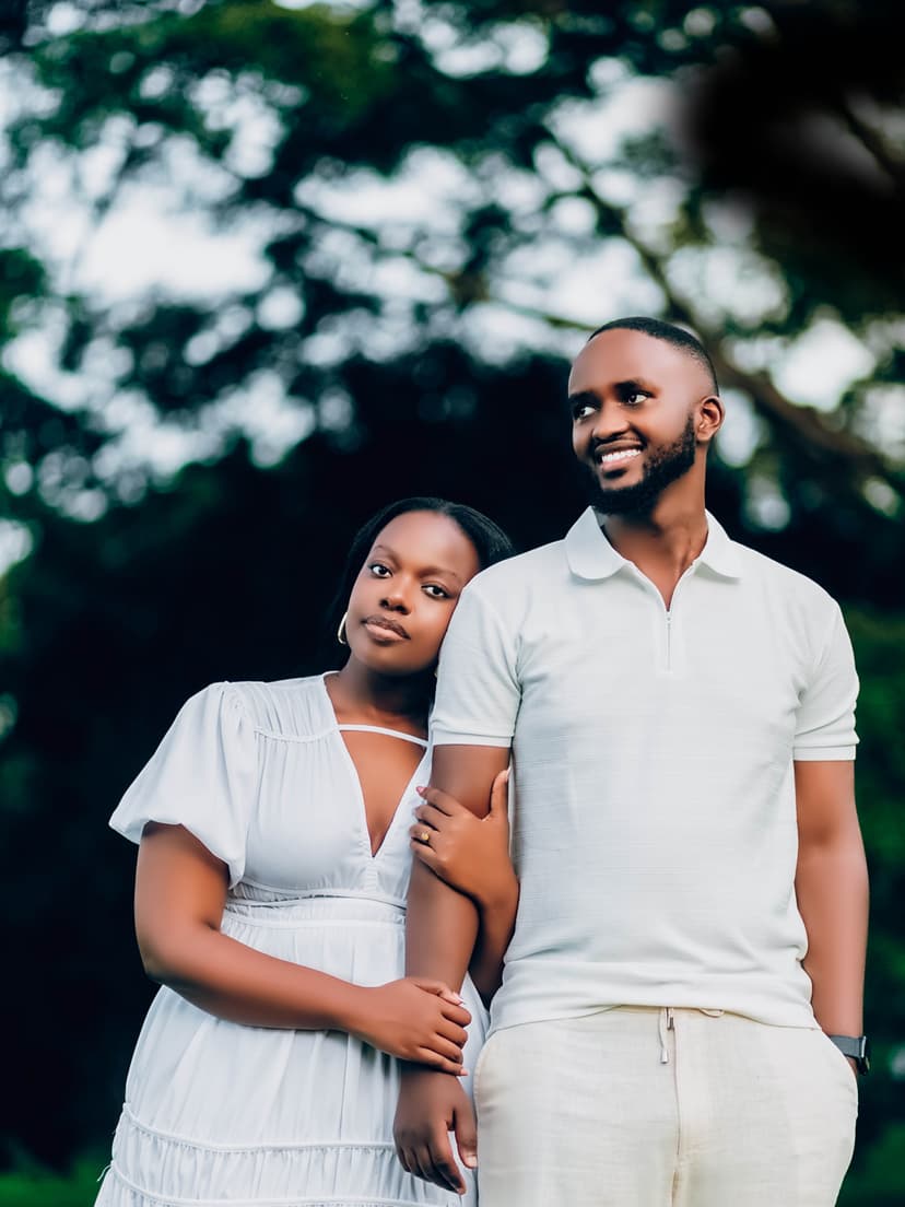 Couple in casual white with blurred flowers