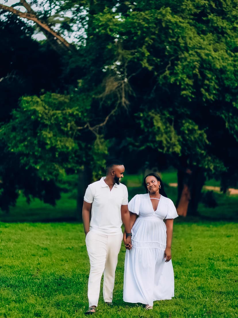 Couple holding hands in garden with trees