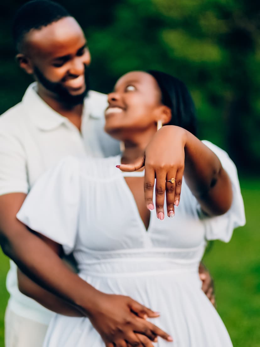 Couple showing wedding ring with sunset glow