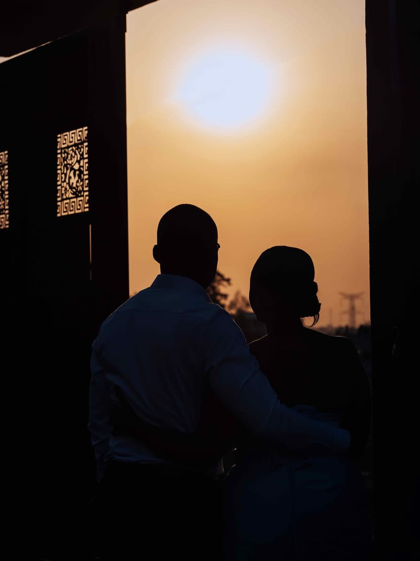 Silhouette couple at door with sunset glow