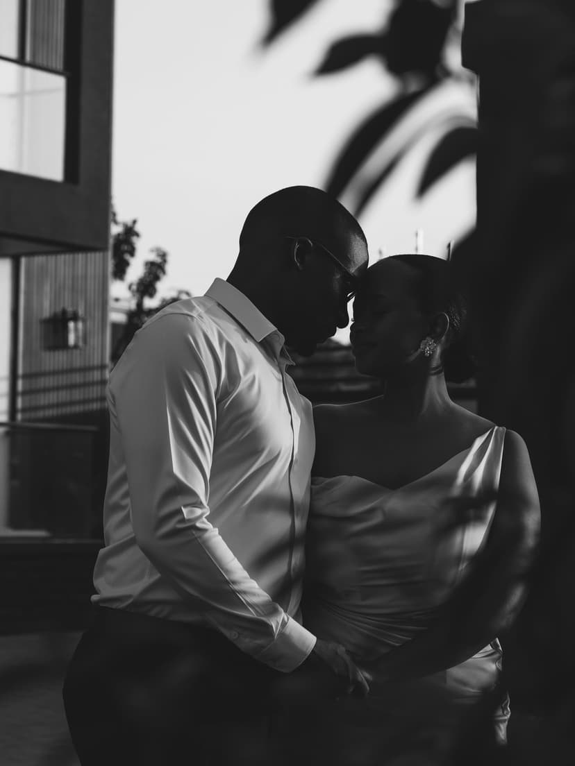 Black and white couple kissing at doorway