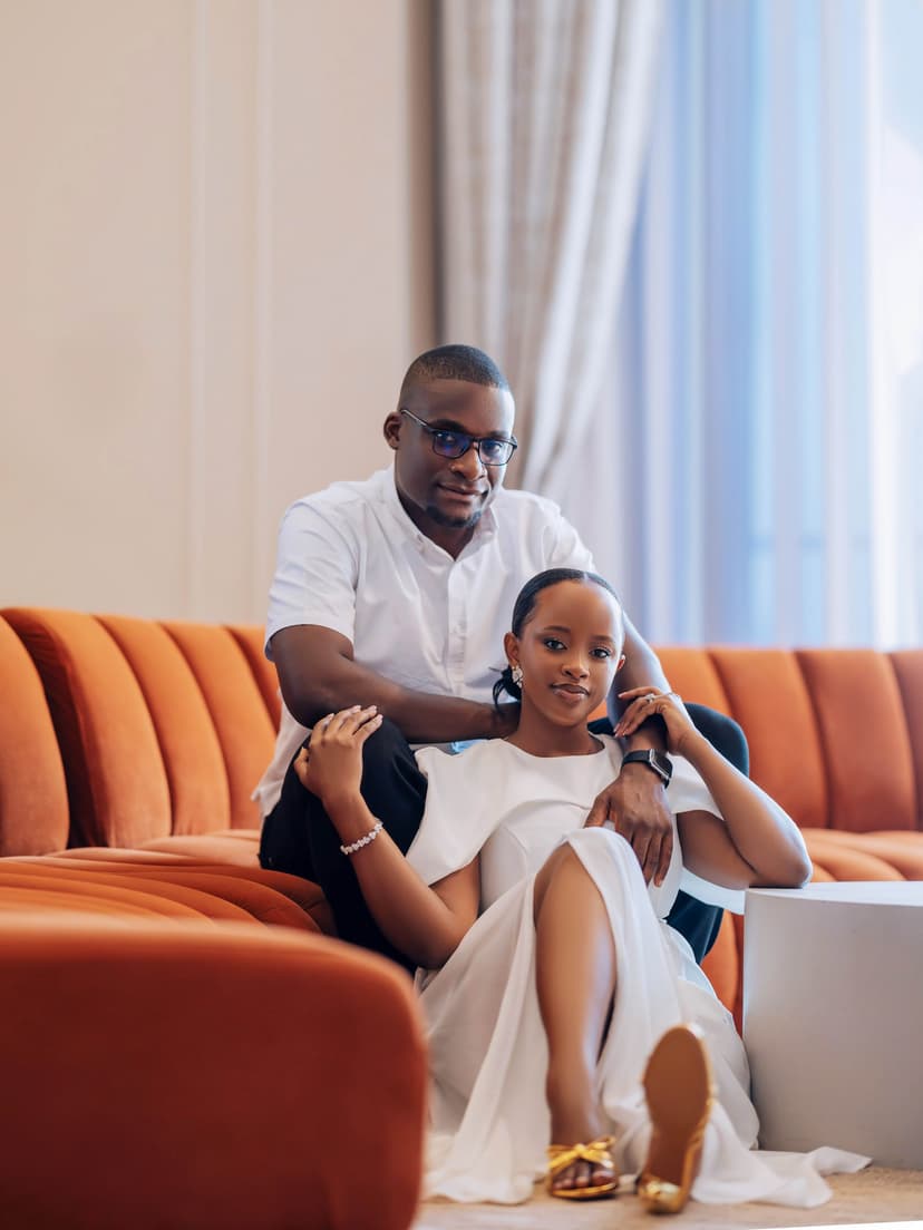 Couple on modern orange sofa in casual whites