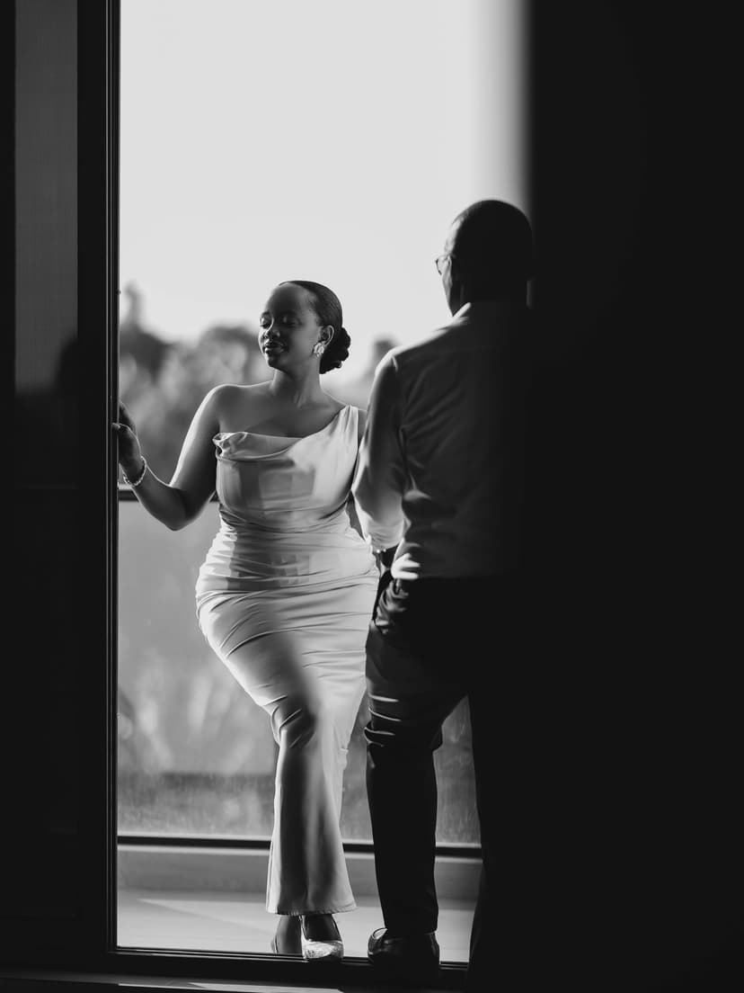 Black and white couple by window in elegant dress